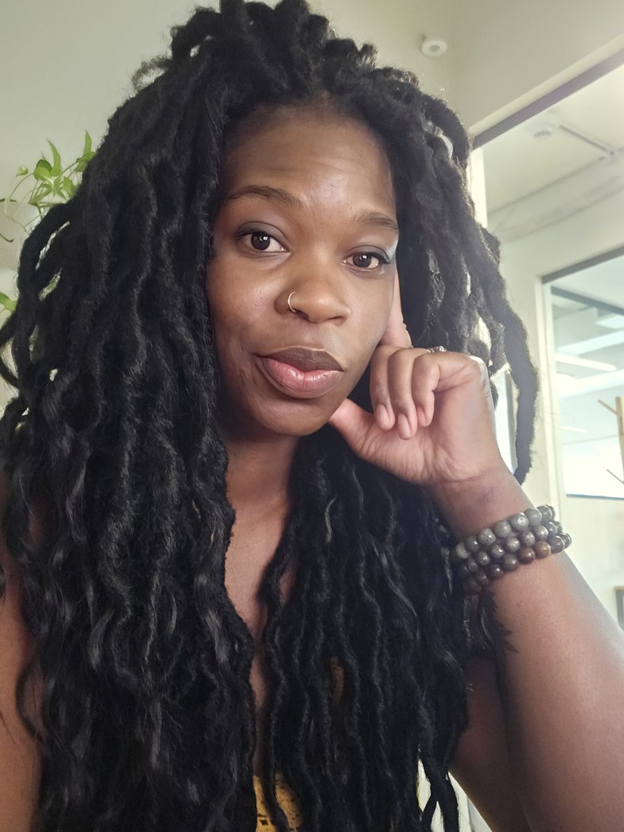 Charisse Fontes, executive and people ops advisor, smiling softly with her hand by her cheek